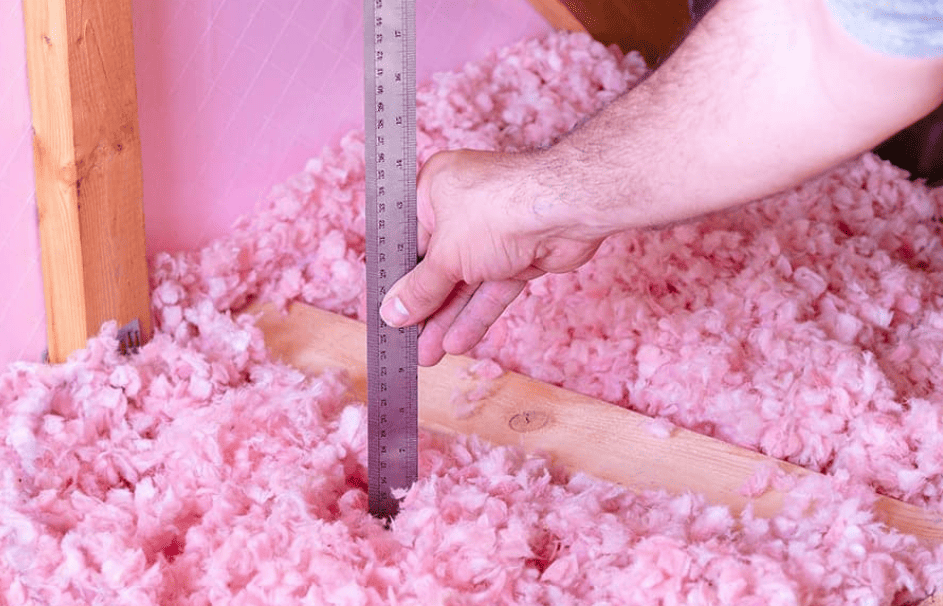 A Service Champions expert checks pink attic insulation with care, making sure your Southern California home stays comfortable and efficient.